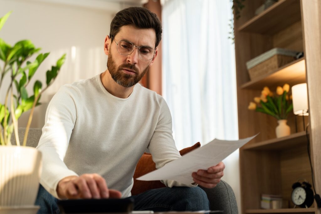 serious man wearing glasses holding paper checkin 2024 10 22 05 35 41 utc